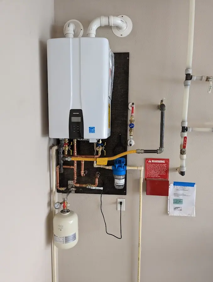 Professional plumber installing copper piping in a Pelham home